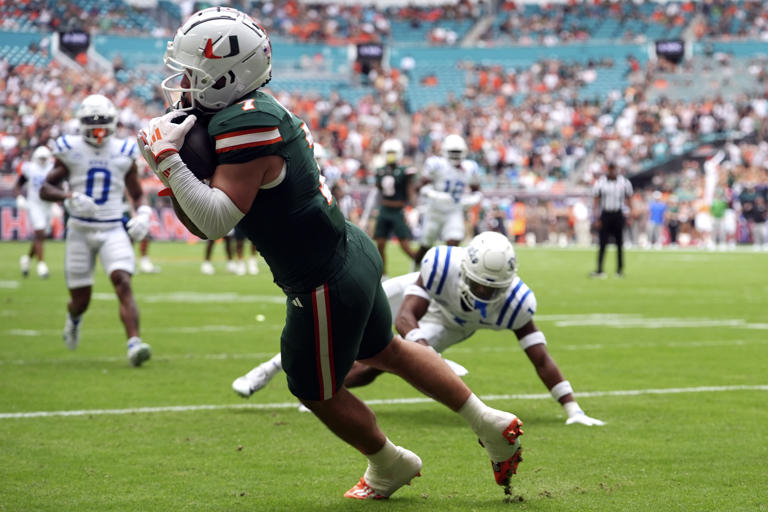 Miami wide receiver Xavier Restrepo (7) makes a catch for a touchdown during the first half of an NCAA college football game against Duke, Saturday, Nov. 2, 2024, in Miami Gardens, Fla. (AP Photo/Lynne Sladky)