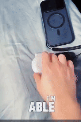 Hand holding a device next to a phone case and headphones, with text saying