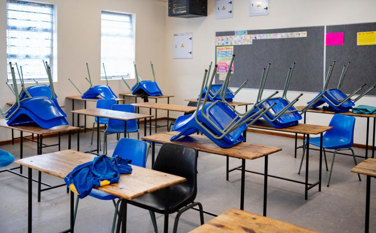 Empty classroom in school with chairs on the table