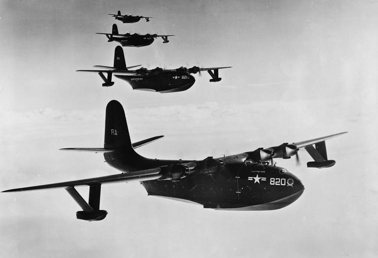 Four Martin JRM-3 Mars flying boats in formation. In the foreground is Philippine Mars, Bu. No. 76820. The second airplane is Marianas Mars, Bu. No. 76821. (U.S. Navy)