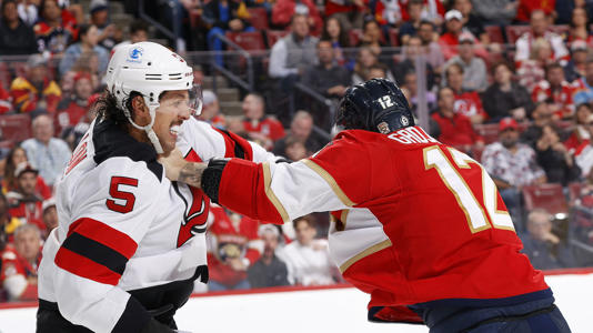 Brenden Dillon and Jonah Gadjovich fight in the second period of Tuesday night’s game.