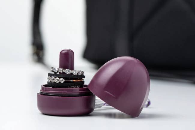 small purple ring holder with twist-on lid