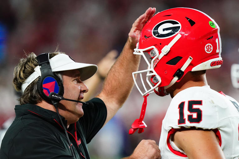 Georgia Bulldogs head coach Kirby Smart talks with quarterback Carson Beck. John David Mercer-Imagn Images