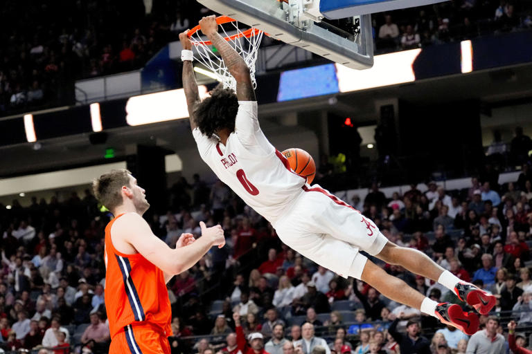 Nov 20, 2024; Birmingham, AL, USA; Alabama guard Labaron Philon (0) gets a dunk with Illinois center Tomislav Ivisic (13) trailing in the CM Newton Classic at Legacy Arena. Alabama defeated Illinois 100-87. Mandatory Credit: Gary Cosby Jr.-Tuscaloosa News