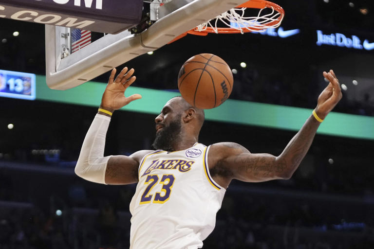 Los Angeles Lakers forward LeBron James dunks during the first half of an NBA basketball game against the Denver Nuggets, Saturday, Nov. 23, 2024, in Los Angeles. (AP Photo/Mark J. Terrill)