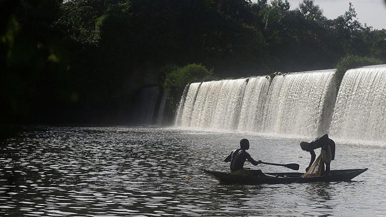 Fishermen paddle their canoe near a dam that sources the sacred river in Esa-Odo Nigeria, on Saturday, 28 May 2022.