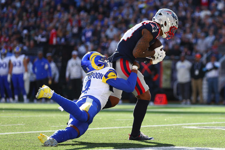 FOXBOROUGH, MASSACHUSETTS - NOVEMBER 17: Kendrick Bourne #84 of the New England Patriots scores a first quarter touchdown as Ahkello Witherspoon #4 of the Los Angeles Rams attempts to make a tackle at Gillette Stadium on November 17, 2024 in Foxborough, Massachusetts. (Photo by Maddie Meyer/Getty Images)