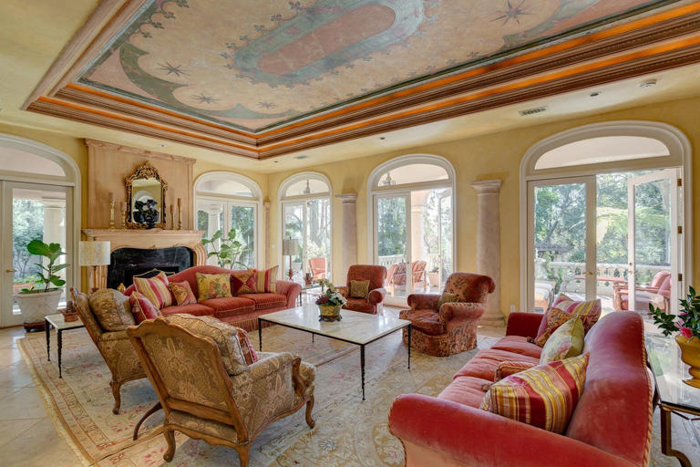 Hand-painted fresco ceilings, evident in this well-appointed living room, are common in Kevin Costner’s former La Cañada Flintridge home.