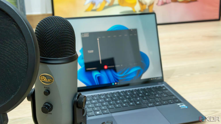 A Blue Yeti microphone in front of a Windows 11 laptop with Sound Recorder open