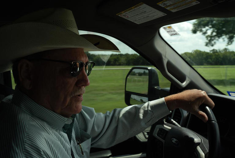 County Commissioner Larry Woolley drives past PFAS-affected land in Grandview on July 29, 2024. Credit: Azul Sordo for The Texas Tribune