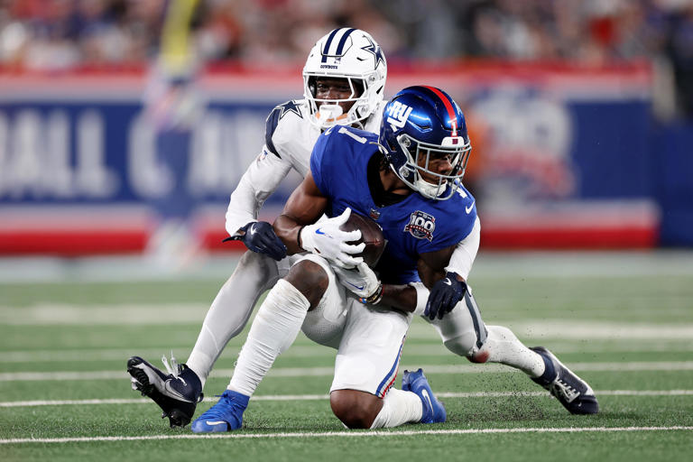 EAST RUTHERFORD, NEW JERSEY - SEPTEMBER 26: Andrew Booth Jr. #25 of the Dallas Cowboys tackles Malik Nabers #1 of the New York Giants during the second quarter at MetLife Stadium on September 26, 2024 in East Rutherford, New Jersey. (Photo by Luke Hales/Getty Images)