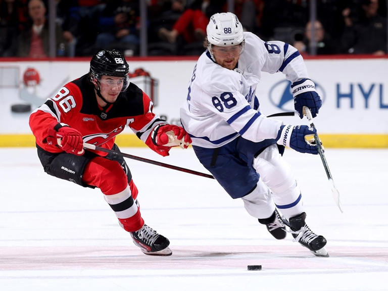 William Nylander (88) of the Toronto Maple Leafs and Jack Hughes (86) of the New Jersey Devils go after the puck in the third period at Prudential Center on Tuesday, Dec. 10, 2024, in Newark, N.J. The Toronto Maple Leafs defeated the New Jersey Devils 2-1 in overtime. 