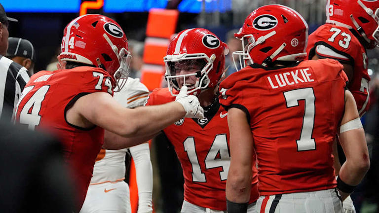 Georgia quarterback Gunner Stockton (14) celebrates with his teammates after leading the offense to a touchdown score after Georgia quarterback Carson Beck (15) had to leave the game during the second half of the SEC championship game against Texas in Atlanta, on Saturday, Dec. 7, 2024. | Joshua L. Jones / USA TODAY NETWORK via Imagn Images