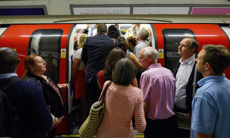 Underground commuters board a train at Moorgate. Bus and tram fares will remain frozen. Photograph: Anadolu Agency/Getty Images