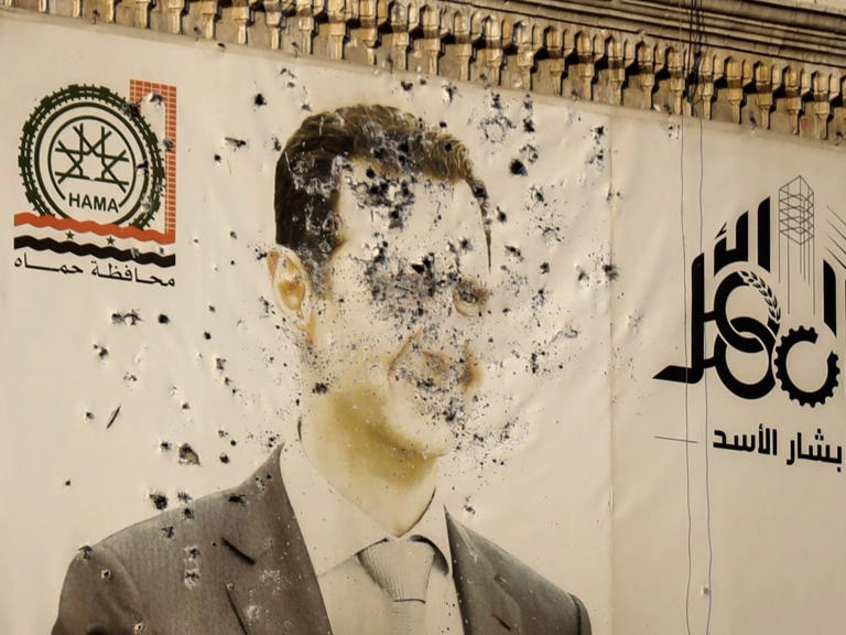 An image of ousted Syrian President Bashar Assad covers the facade of a provincial government office in the aftermath of the opposition's takeover of Hama, Syria, Dec. 6, 2024.