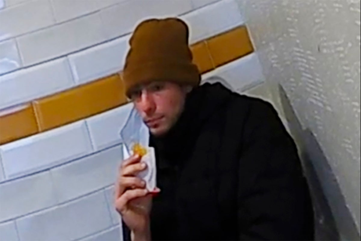 Mangione eating a hash brown in a McDonald’s on Monday before his arrest (AP)