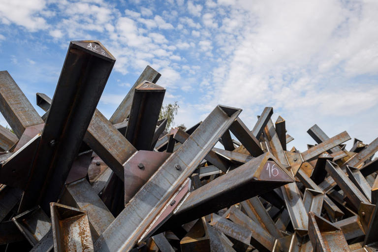 Anti-tank hedgehogs (back) and concrete blocks (front) are seen during a press tour to present military reinforcement measures near the border of Latvia with Russia, on August 16, 2024 in Karsava, Latvia. The Latvian government has said around €303 million will be funneled into building up defenses on the eastern border with Russia over five years. GINTS IVUSKANS/AFP via Getty Images