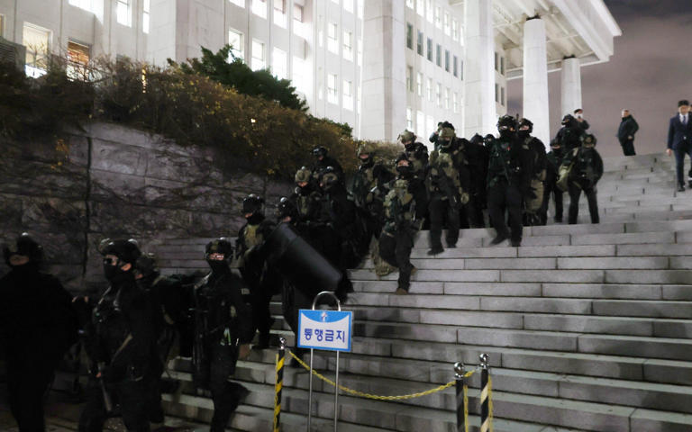 Soldiers withdraw from the National Assembly in Seoul after MPs voted to revoke martial law - YONHAP/EPA-EFE/Shutterstock/Shutterstock