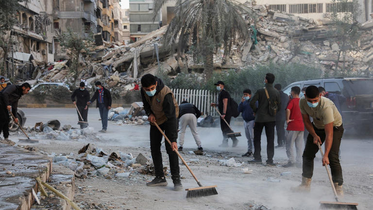 Members of Imam al-Mahdi scouts clean rubble and debris from damaged buildings in Beirut's southern suburbs after the cease-fire between Israel and Hezbollah, in Lebanon on Dec. 2, 2024. Reuters Photos