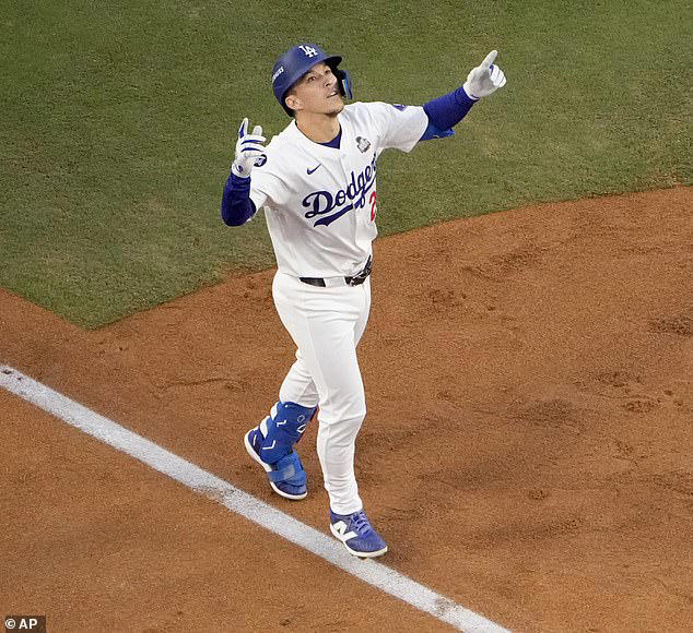 Tommy Edman celebrates as he reaches home plate after his solo home run in Game 2 