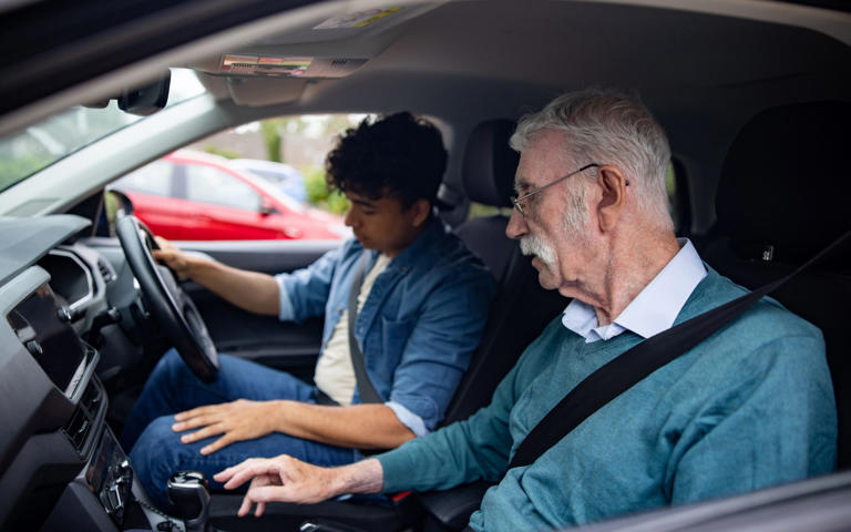 Driving instructor in car with learner