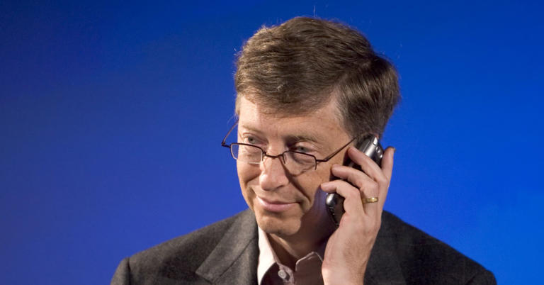 Bill Gates, holding a Palm Treo smartphone during a press conference in 2005.