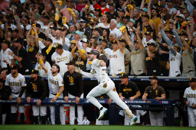 The San Diego Padres' Jackson Merrill hits a triple against the Atlanta Braves in the second inning during Game 2 of the N.L.