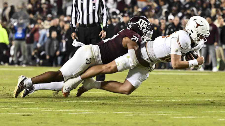 Nov 30, 2024; College Station, Texas, USA; Texas A$M Aggies linebacker Taurean York (21) tackles Texas Longhorns quarterback Arch Manning (16) during the second half. The Longhorns defeated the Aggies 17-7 at Kyle Field. Mandatory Credit: Maria Lysaker-Imagn Images | Maria Lysaker-Imagn Images