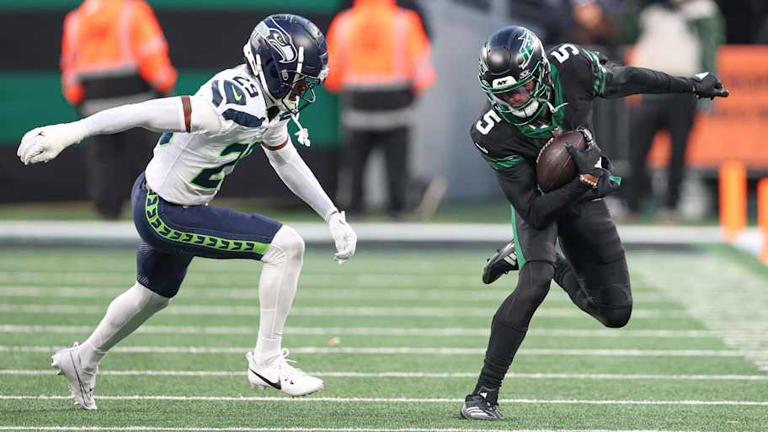 Dec 1, 2024; East Rutherford, New Jersey, USA; New York Jets wide receiver Garrett Wilson (5) fights for yards as Seattle Seahawks cornerback Josh Jobe (29) defends during the second half at MetLife Stadium. | Vincent Carchietta-Imagn Images