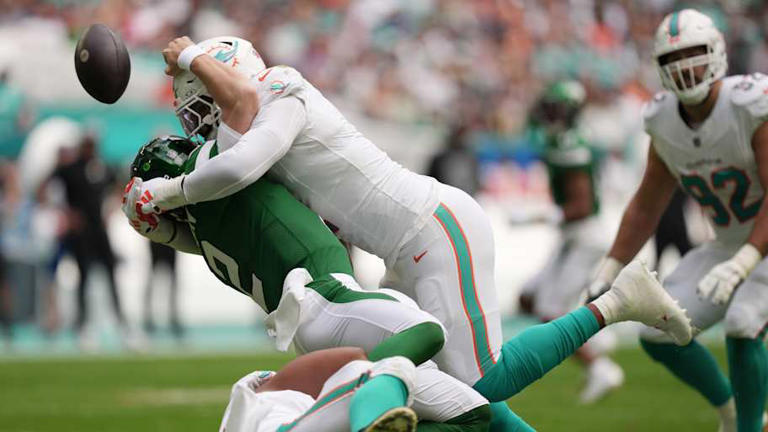 Miami Dolphins linebacker Bradley Chubb, top, and defensive tackle Christian Wilkins, bottom, hit New York Jets quarterback Zach Wilson (2) causing a fumble during the first half of an NFL game at Hard Rock Stadium in Miami Gardens, Dec. 17, 2023. | Jim Rassol / USA TODAY NETWORK