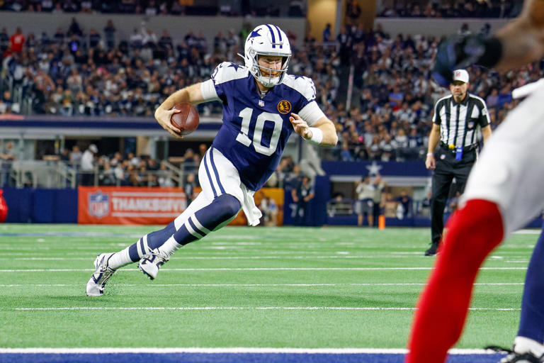 Nov 28, 2024; Arlington, Texas, USA; Dallas Cowboys quarterback Cooper Rush (10) runs for the end-zone during the second quarter against the New York Giants at AT&T Stadium. Mandatory Credit: Andrew Dieb-Imagn Images