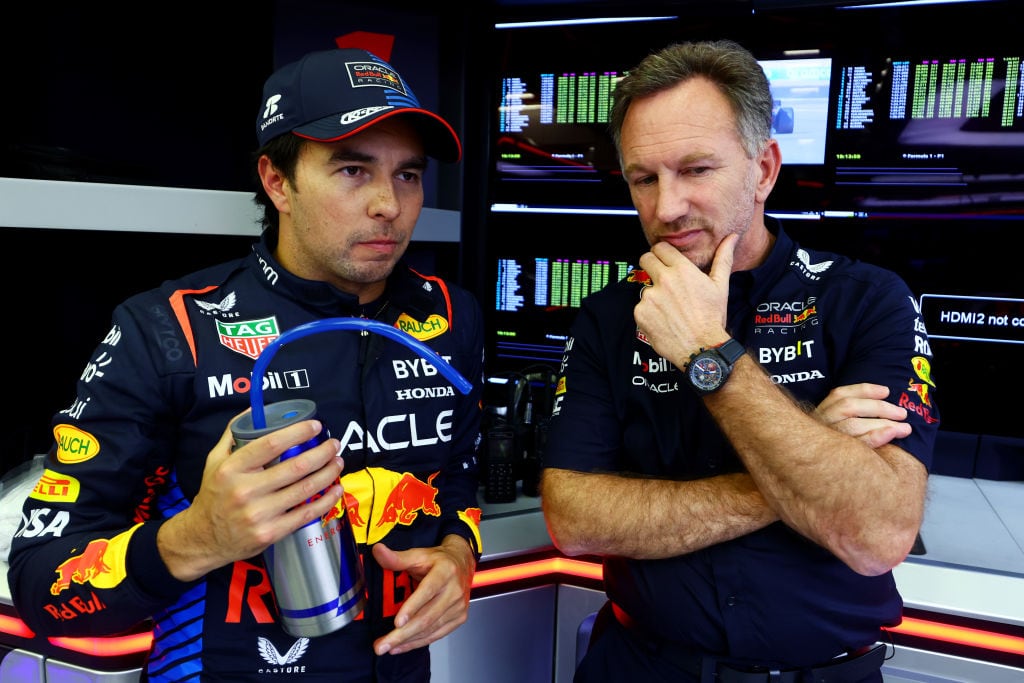 BAHRAIN, BAHRAIN - FEBRUARY 22: Sergio Perez of Mexico and Oracle Red Bull Racing and Oracle Red Bull Racing Team Principal Christian Horner look on in the garage during day two of F1 Testing at Bahrain International Circuit on February 22, 2024 in Bahrain, Bahrain. (Photo by Mark Thompson/Getty Images)