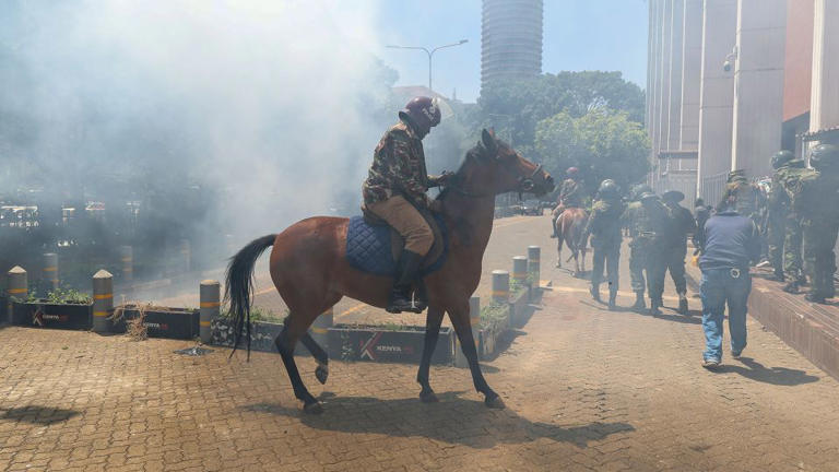 A mounted anti-riot police officer tries to escape the teargas used to disperse activists during a protest against the rise in alleged abductions of government critics, in Nairobi, Kenya, on Monday. - Daniel Irungu/EPA-EFE/Shutterstock