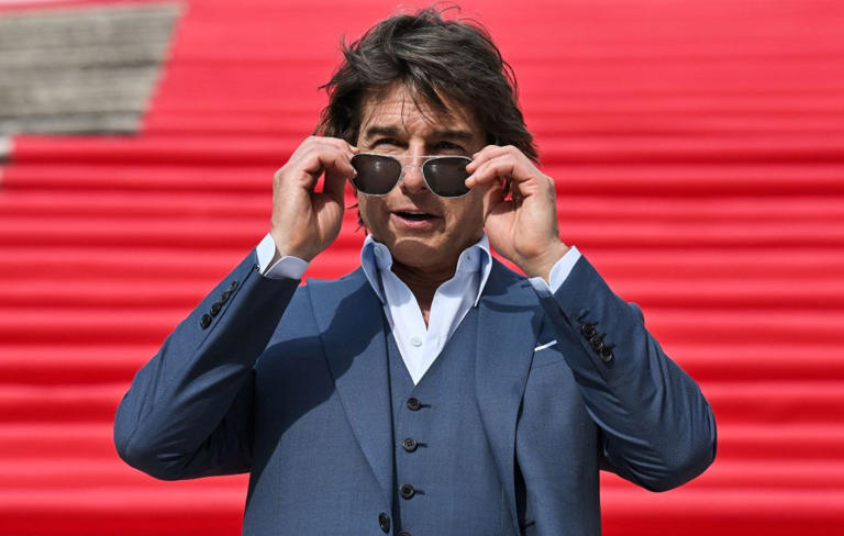 Tom Cruise puts on his sunglasses as he poses on the Spanish Steps ahead of the premiere of "Mission: Impossible - Dead Reckoning Part One" movie in Rome, on June 19, 2023.