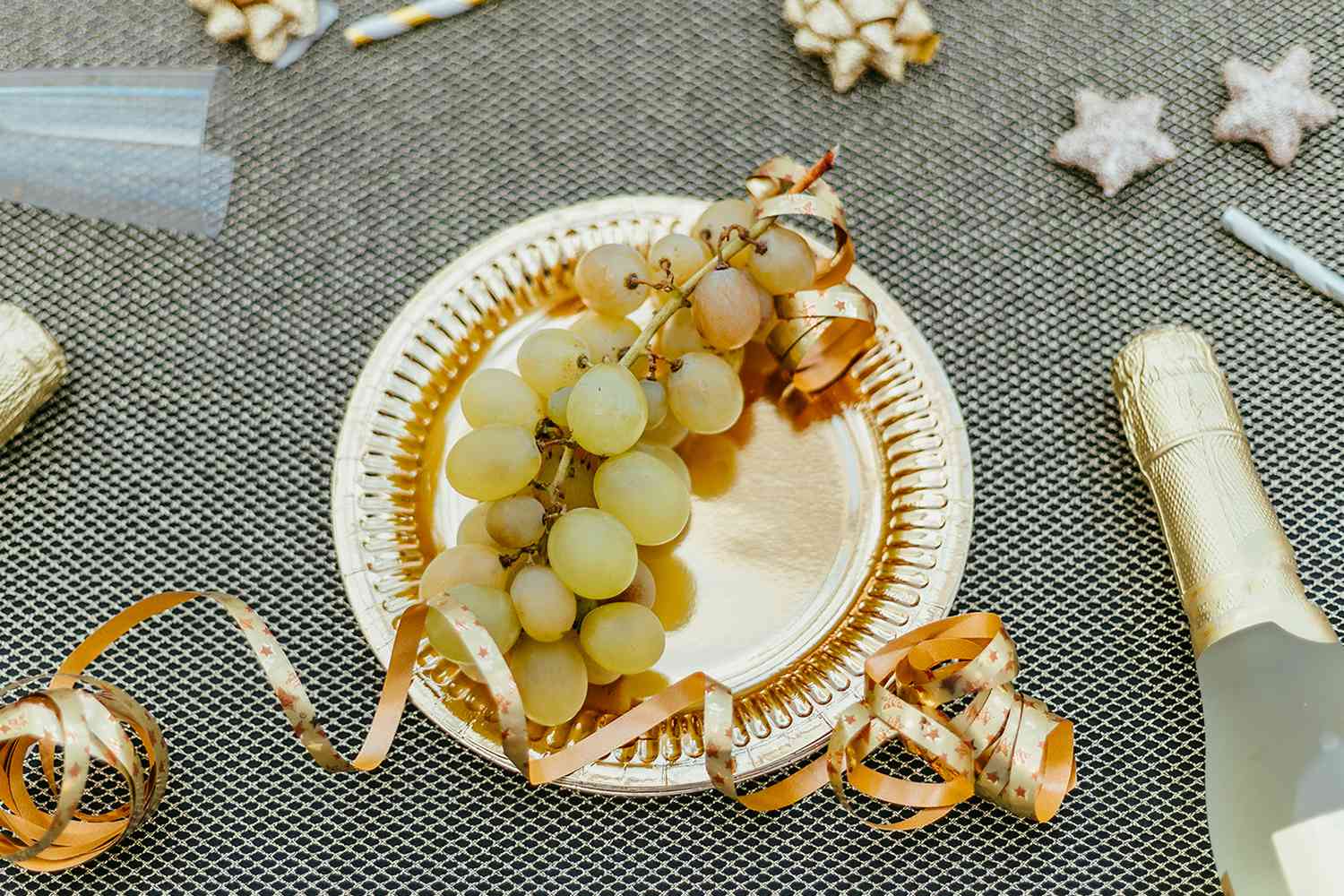 People Are Manifesting Engagements in 2025 by Eating Grapes Under a Table on New Year's Eve: All