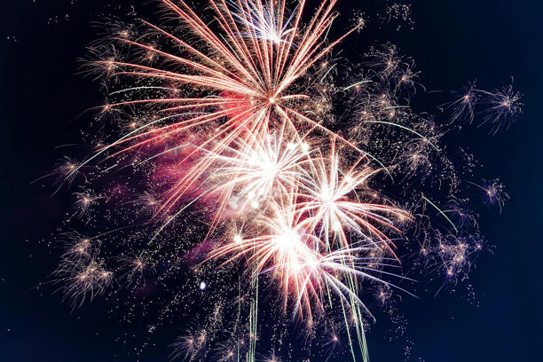 Colorful fireworks exploding in the night sky creating a festive atmosphere.