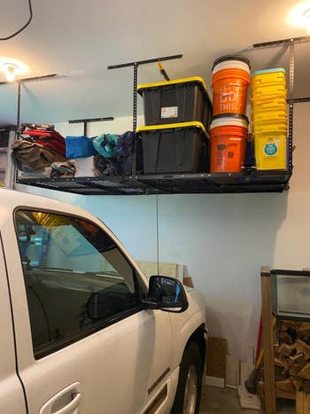 reviewer image of the storage shelves attached to the ceiling of their garage