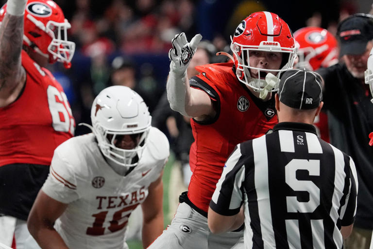 Georgia tight end Oscar Delp (4) celebrates after getting a first down during overtime of the SEC championship game against Texas in Atlanta, on Saturday, Dec. 7, 2024.