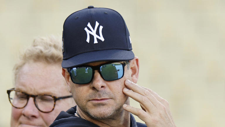 Aaron Boone touching his face