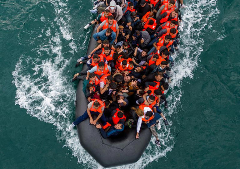 FILE PHOTO: In this drone view an inflatable dinghy carrying migrants makes its way towards England in the English Channel, Britain, August 6, 2024. REUTERS/Chris J. Ratcliffe/File Photo