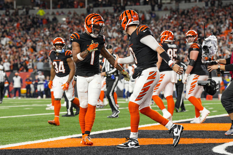 Cincinnati Bengals quarterback Joe Burrow (9) celebrates with wide receiver Ja'Marr Chase (1) after a touchdown against the Denver Broncos during the second half of an NFL football game in Cincinnati, Saturday, Dec. 28, 2024. (AP Photo/Jeff Dean)