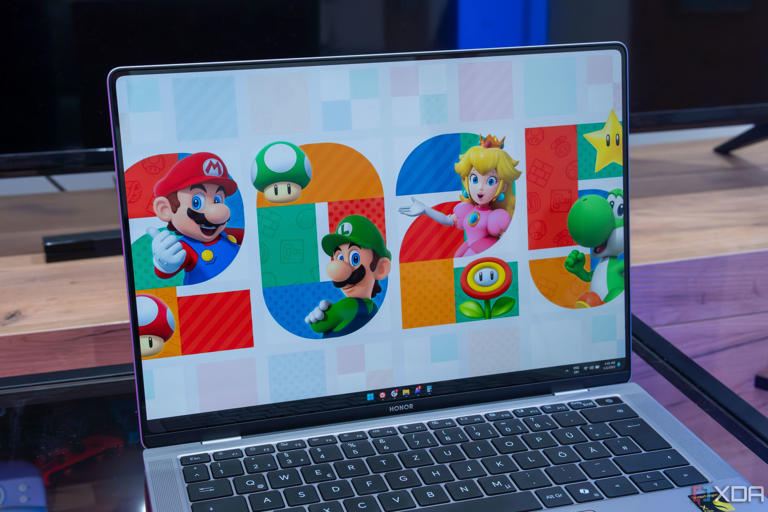 Angled view of the Honor MagicBook Art 14's display showing the Windows 11 desktop with a background showing the number 2025