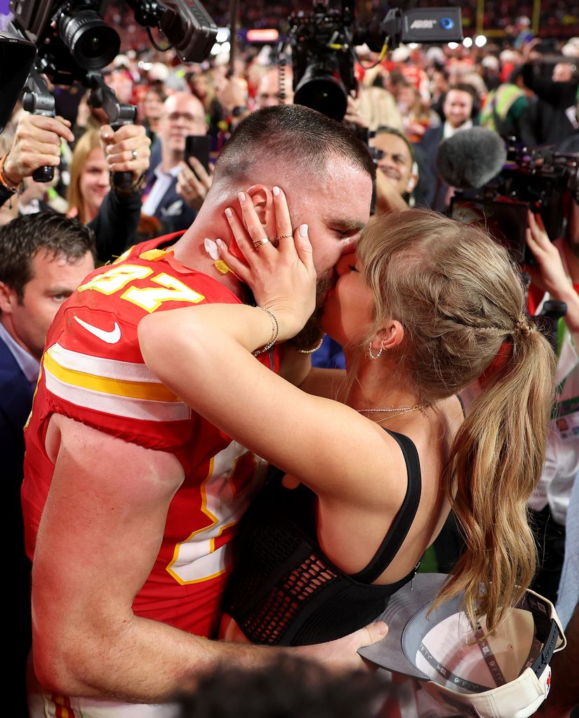 Travis Kelce #87 of the Kansas City Chiefs kisses Taylor Swift after defeating the San Francisco 49ers