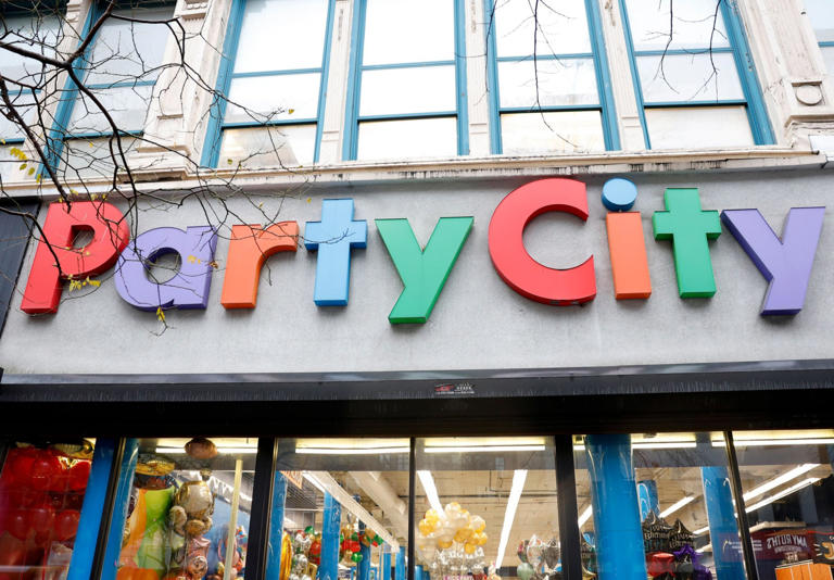 Pedestrians walk by a Party City retail store in New York City on Friday (Picture: Shutterstock)