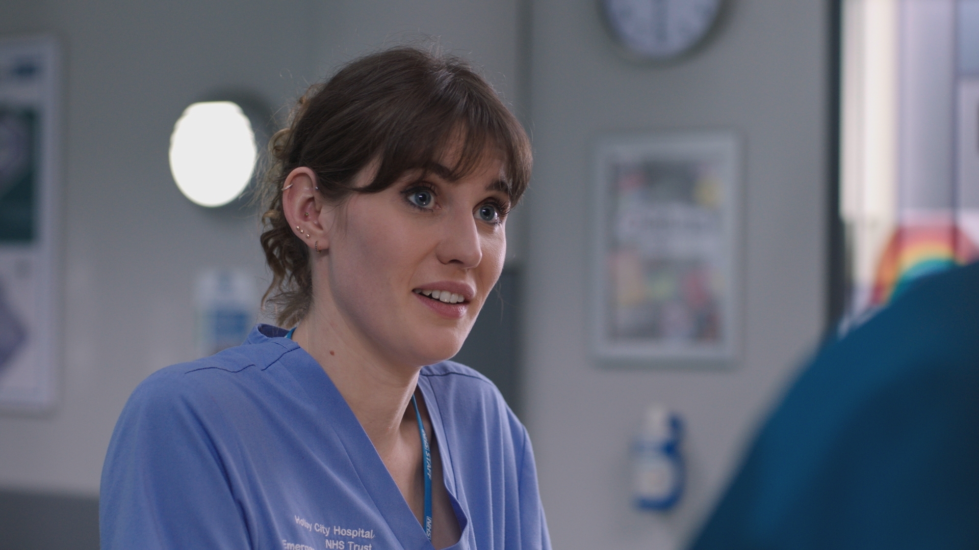 Jodie's face lights up when Dylan offers his professional support during a tough shift at Holby ED. (Image credit: BBC Studios. )