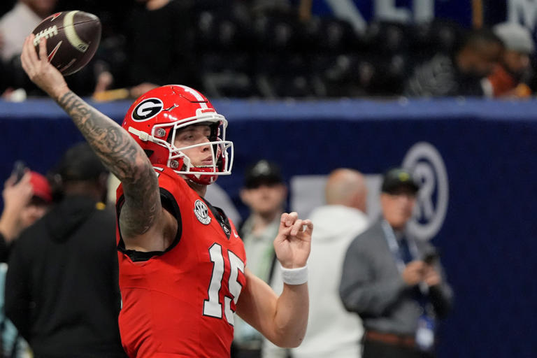 Georgia quarterback Carson Beck (15) warms up before the start of the SEC championship game against Texas in Atlanta, on Saturday, Dec. 7, 2024.