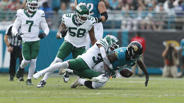 Dec 15, 2024; Jacksonville, Florida, USA; New York Jets cornerback Michael Carter II (30) forces Jacksonville Jaguars running back Tank Bigsby (4) to fumble during the first quarter at EverBank Stadium. | Morgan Tencza-Imagn Images