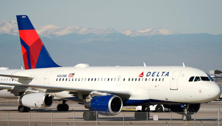 Delta Airlines jetliner taxis down a runway as it arrives at Denver International Airport, Tuesday, Dec. 24, 2024, in Denver. (AP Photo/David Zalubowski)