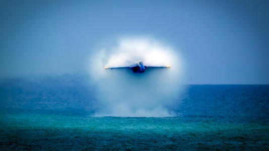 a Blue Angels jet breaks sound barrier right over the water