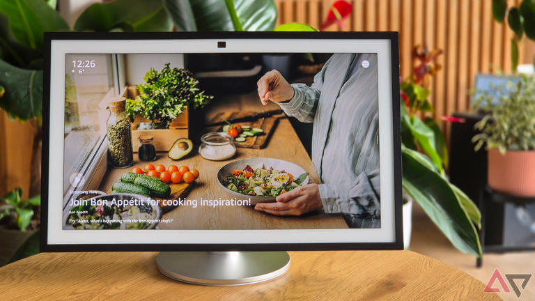 Amazon Echo Show 21 on a table with plants in the background